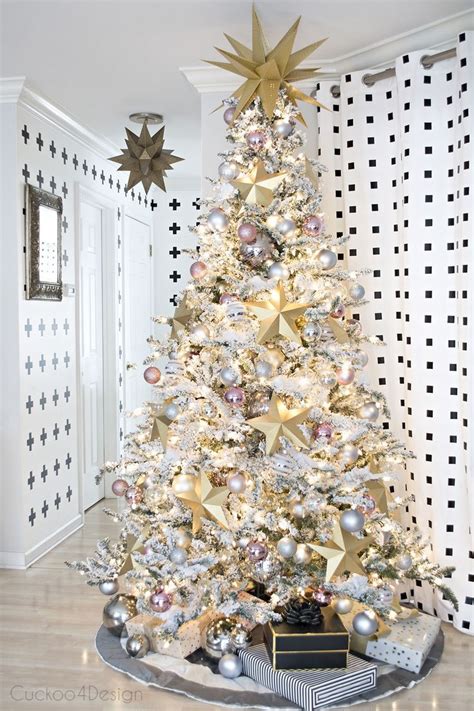flocked Christmas tree with large gold paper stars and blush and