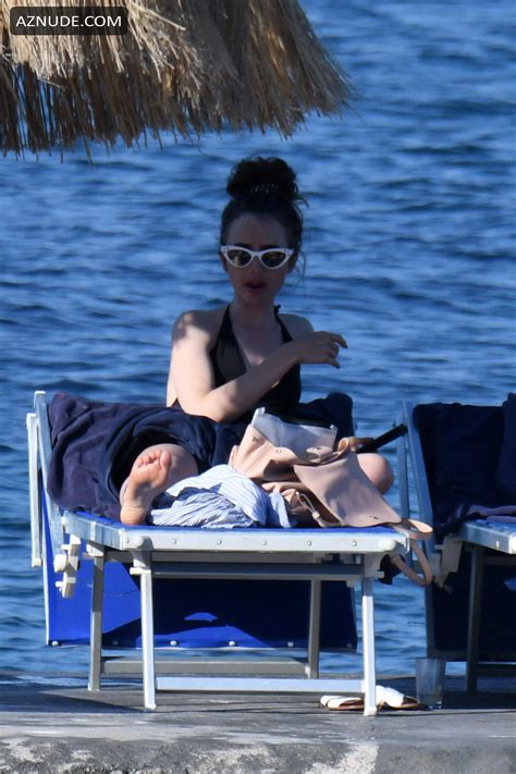 Lily Collins Sexy In A Black Swimsuit On Holiday In Ischia Aznude