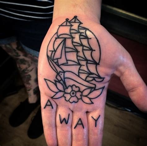 simple homemade style black ink ship with flower with lettering tattoo on hand tattooimages