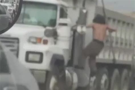 Man Strips Naked Climbs On Top Of Car And Starts Stabbing Its Roof In Bizarre Road Rage