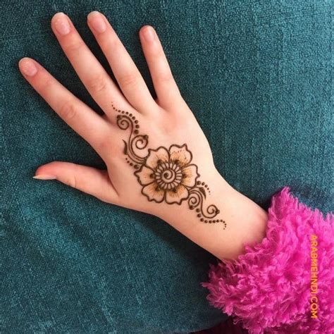 A Woman S Hand With A Henna Tattoo On Her Left Wrist And Pink Ruffles
