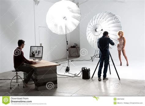 Photographer Working With A Cute Model In A Professional Studio Stock