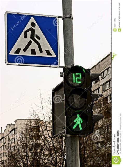 Road Sign Pedestrian Crossing And Traffic Light With Green Light Stock