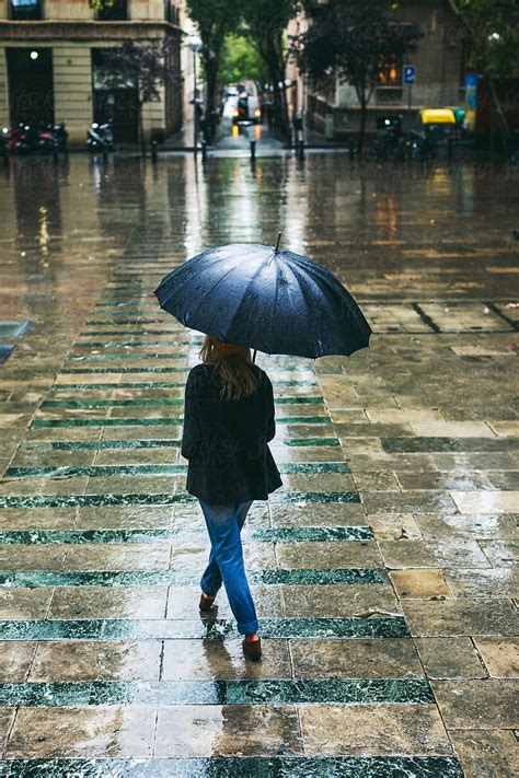 Back View Of A Woman Walking On The Street In A Rainy Day Del