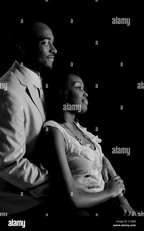 Romantic African American Couple Looking With Dreamy Eyes To The Right In Black And White Stock