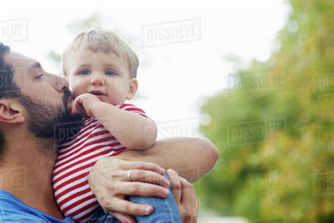 Caucasian Father Kissing Baby Son Stock Photo Dissolve