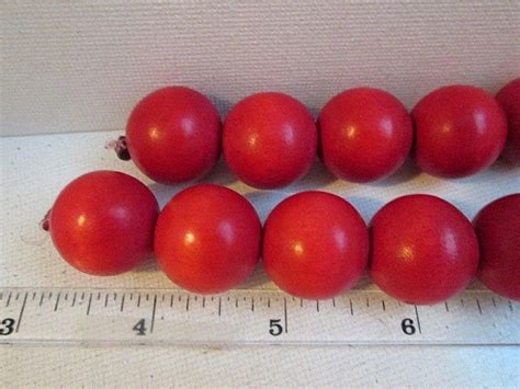 Red Tomatoes Are Lined Up Next To A Ruler