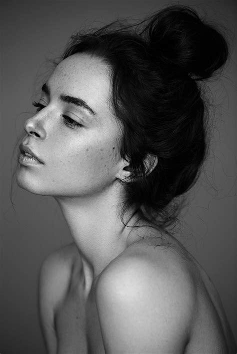 A Black And White Photo Of A Woman With Freckles On Her Hair Looking Off To The Side