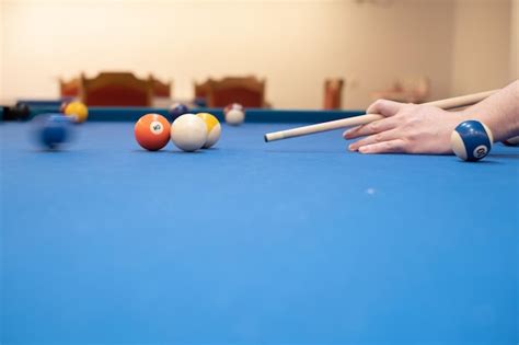 Premium Photo Closeup Of A Mans Hand On A Billiard Table Playing Snooker Preparing To Shoot