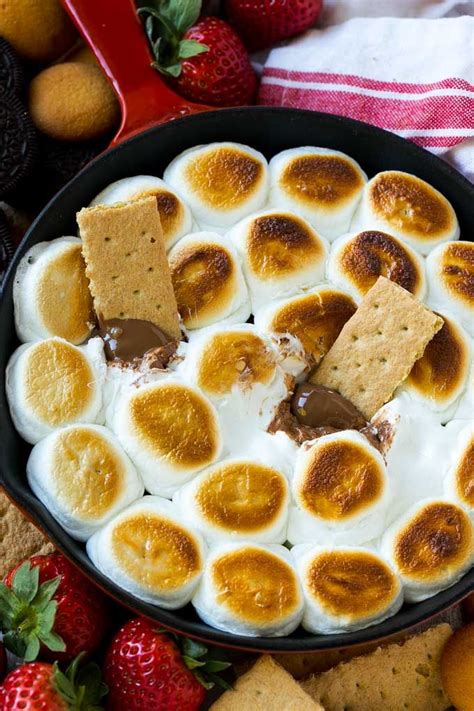 A Skillet Of S Mores Dip With Melted Milk Chocolate Topped With Toasted
