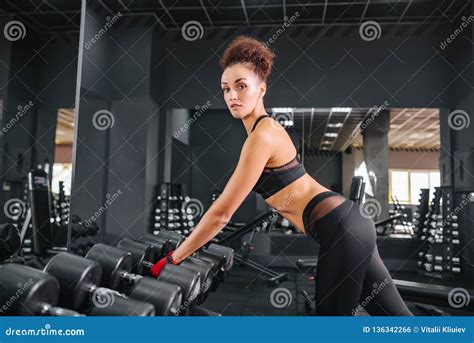 Fitness Woman In The Gym Sport Workout Exercises With Dumbbels Stock