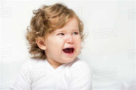 Portrait Of Crying Toddler Girl Looking Away Isolated On White Stock