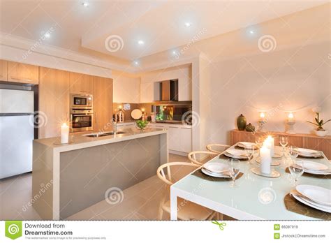 In a chicago family home designed by steve kadlec and sasha adler, the modern kitchen features black lacquered and grass cloth walls and inset vintage brass vitrines, while showcasing the home's fine details through notched edges on the kitchen island countertop. Kitchen And Dinner Table Setup With Candles Flashing Editorial Stock Image - Image of leaf ...