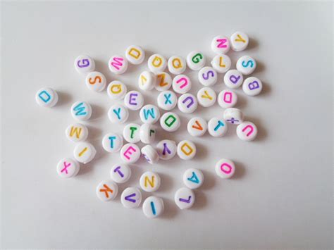 These popular metal alphabet letter beads will fit a variety of bracelets and necklaces. 6.5mm White With Colour Flat Round Mixed Alphabet Beads ...
