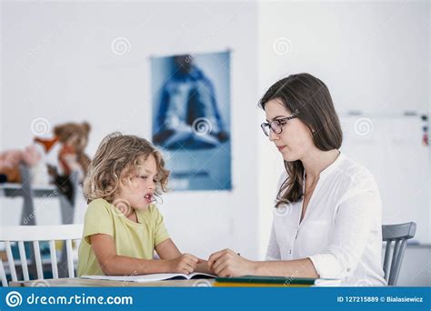 Unhappy Child Refusing To Do Exercises From A Book With A