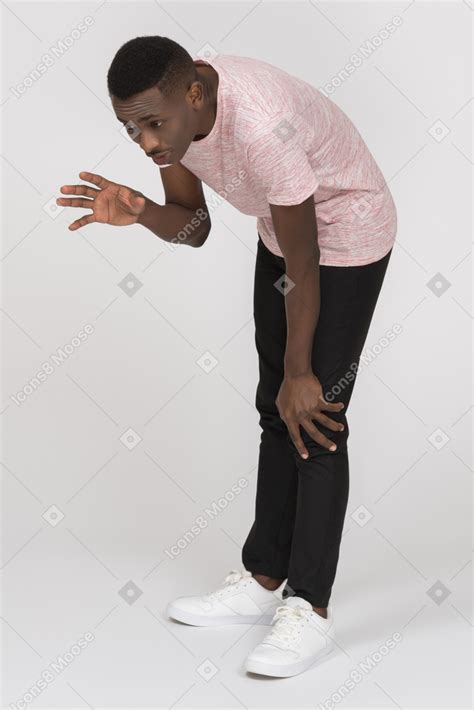 Man Bending Over And Explaining Something With Hand Photo