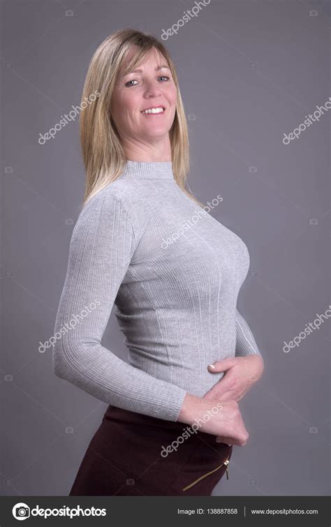 Busty Blonde Woman Wearing A Tight Sweater Stock Photo By ©petertt