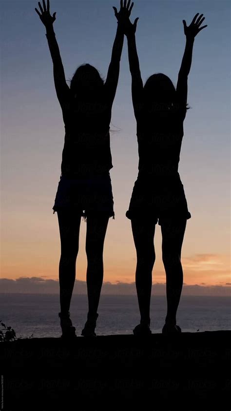 Two Girls At Sunset Raised Arms And Hugging Del Colaborador De Stocksy Nikita Sursin Stocksy