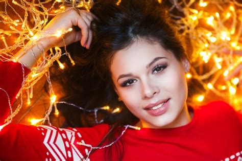 Premium Photo Close Up Portrait Of Woman Wrapped In Christmas Lights Lying On Floor At Home