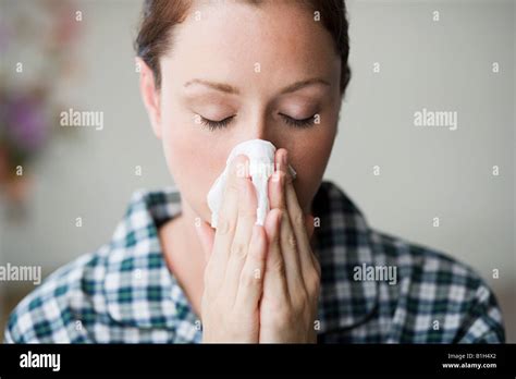 Woman Blowing Her Nose Stock Photo Alamy