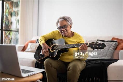Old Woman Playing Guitar Photos And Premium High Res Pictures Getty