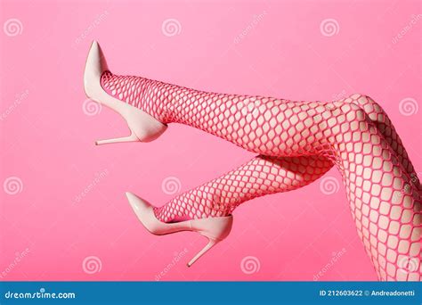 Female Legs Raised In Pink Fishnets And High Heels Stock Photo Image