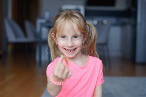 six year smiling happy girl holding a first fallen tooth and looking at him stock image image