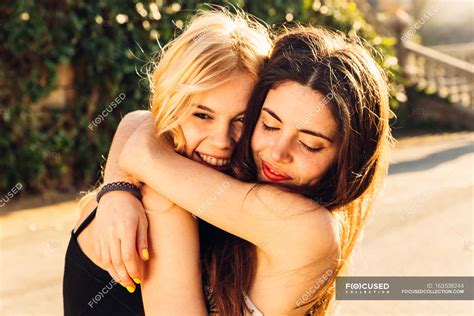 Two Girls Hugging Female Closed Eyes Stock Photo