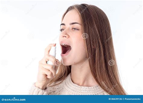 Young Girl Holding A Spray For The Throat And Squirting Closeup Stock