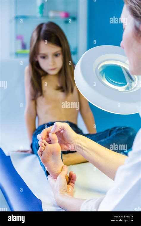doctor examining girls foot stock photo alamy