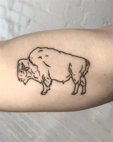 A Black And White Drawing Of A Cow On The Arm