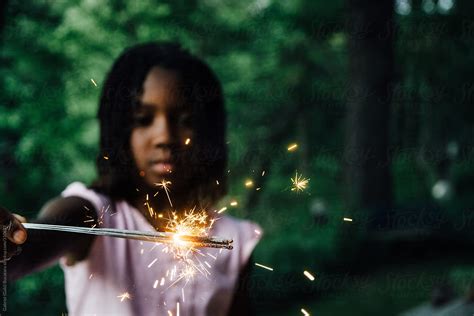 african american girl with a sparkler by stocksy contributor gabi bucataru stocksy