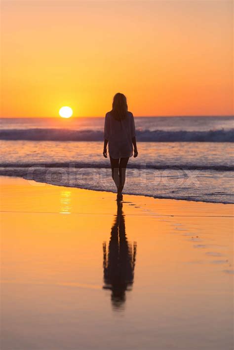 Lady Walking On Sandy Beach In Sunset Stock Image Colourbox