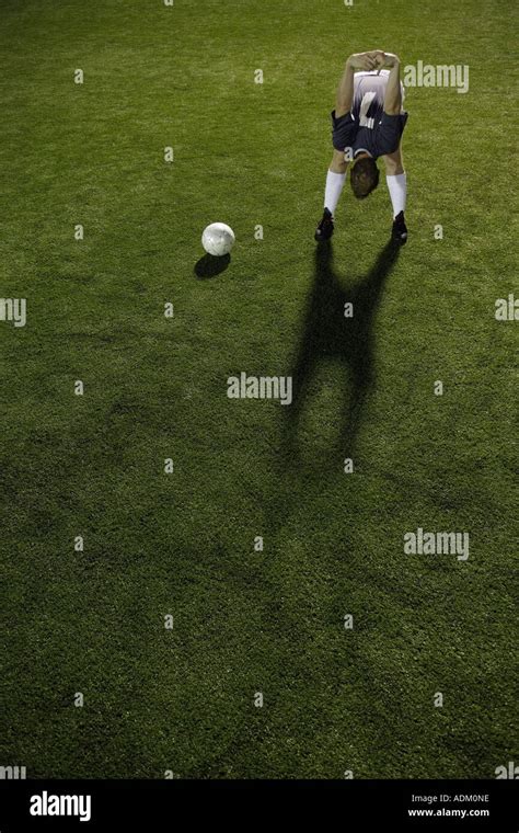 Soccer Player Stretching In Open Field Stock Photo Alamy