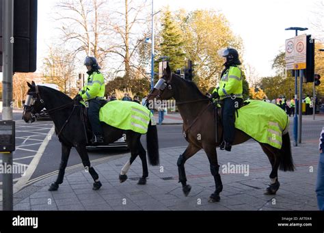 Police On Horses Wearing Protective Equipment Ready To Control Football