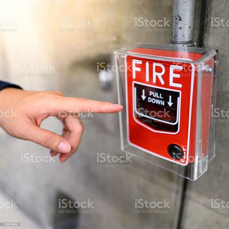 Male Hand Pointing At Red Fire Alarm Switch Stock Photo Download