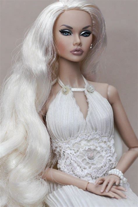 A Barbie Doll With Long White Hair Wearing A Dress And Pearls On Its Head