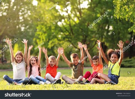 Stock Photo Cute Little Children Sitting On Grass Outdoors On Sunny Day