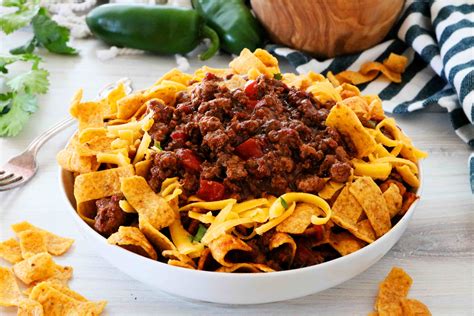Frito Pie In A Bowl Surrounded By Corn Ships And Jalapenos Frito Pie