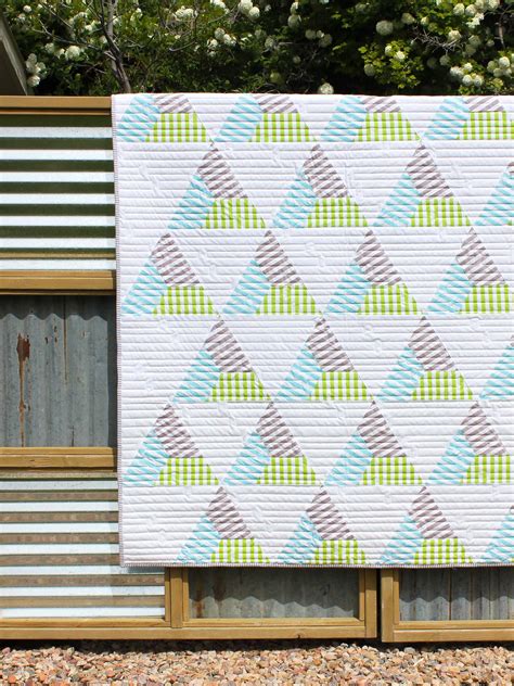 First, place a paper hexie in the center on the back side of your fabric. Stripe-Hexie-Triangle Quilt! - Riley Blake Designs | Triangle quilt, Quilts, Hexie quilt
