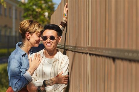 Premium Photo Portrait Of Young Stylish Lesbians Standing Outdoors In Summer Day And Smiling
