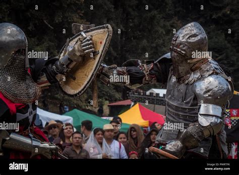 Medieval Knights Fighting With Armor Swords And Shields In Festival