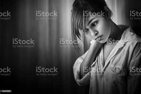 Monochrome Image Of Asian Indian Sad Teenage Girl Looking Down Stock