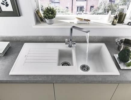 These stone kitchen sinks work well with dark or simple white countertops, creating a minimal design that you'll never grow tired of. Lamona White Granite Composite 1.5 Bowl Sink | Howdens Joinery