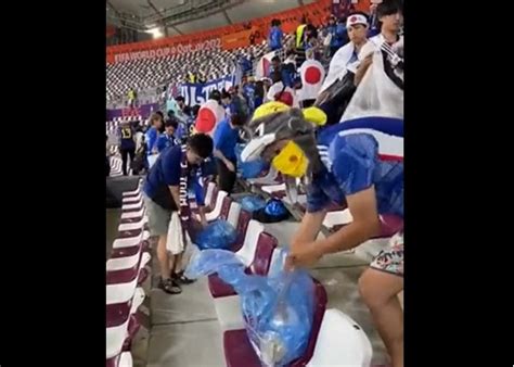 world cup japan fans clean up stadium after win over germany