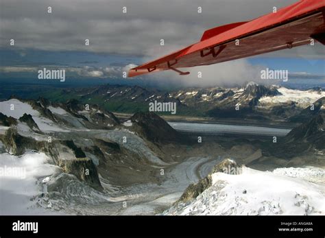 Bush Plane Over Glacier Alaska Stock Photo Alamy