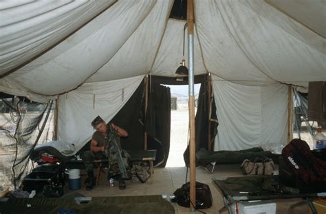 A Member Of The 86th Signal Battalion Sits At His Bunk Between