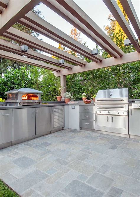 Outdoor Kitchen With Pizza Oven And Stainless Steel Built In Grill By
