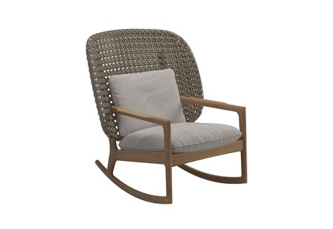This accent chair sits atop slim metal legs, which wrap around to the back. New! Gloster's Kay High back Rocking Chair designed by ...