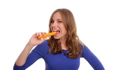 Vigorous Girl Eating A Fresh And Tasty Carrot Stock Footage Video